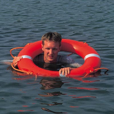 Person in open water using a lifebuoy ring for emergency water rescue and drowning prevention.