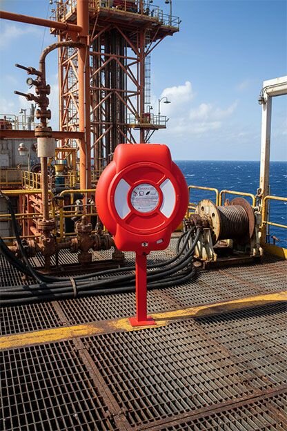 Water safety lifebuoy housing installed at an industrial oil rig near liquid hazards